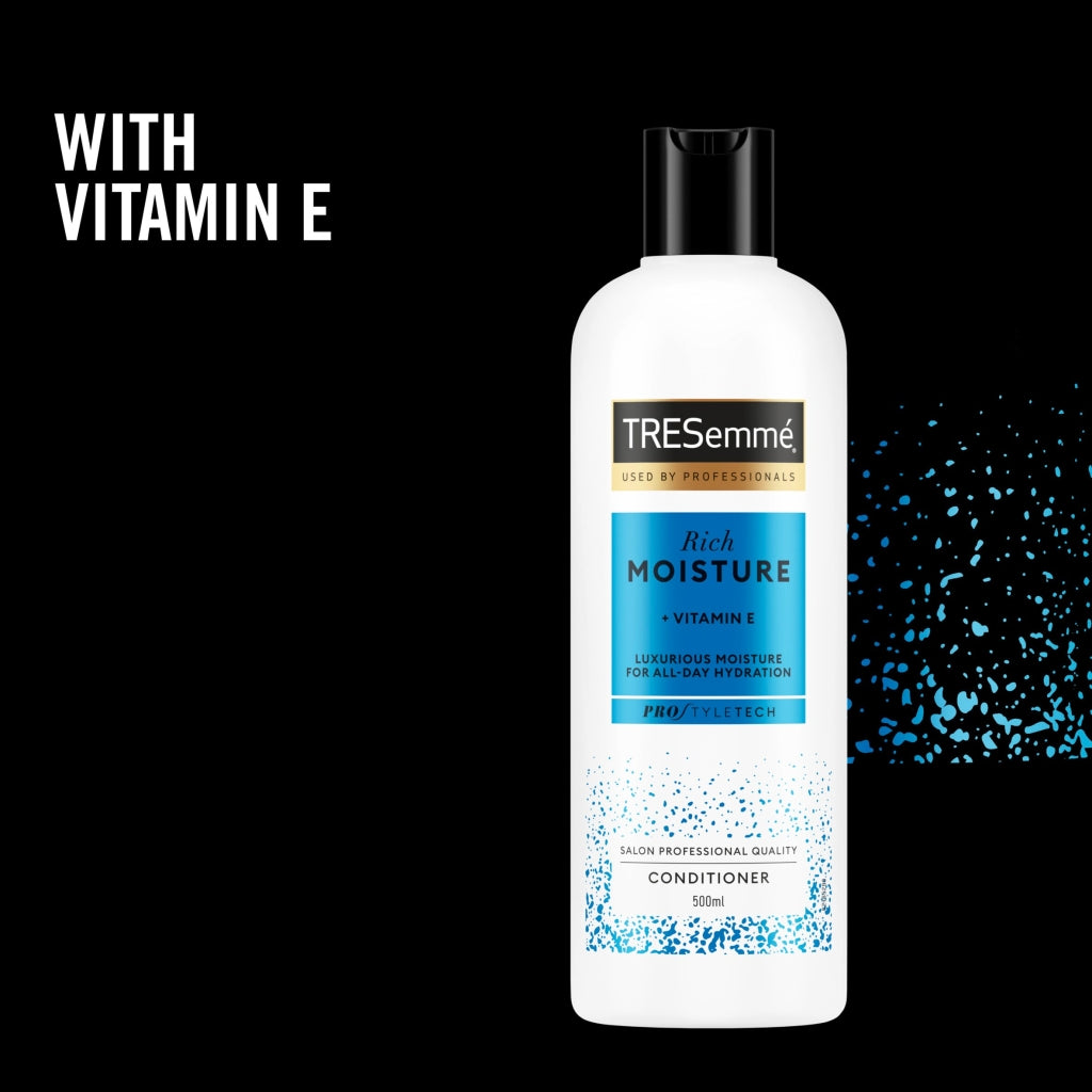 TRESemme Rich Moisture conditioner bottle with Vitamin E on a black background