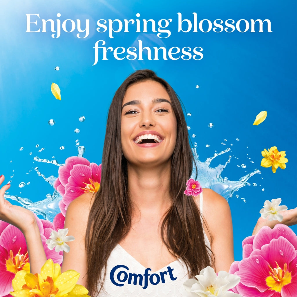 Woman with flowers and 'Comfort' branding against a blue background with text 'Enjoy spring blossom freshness'.